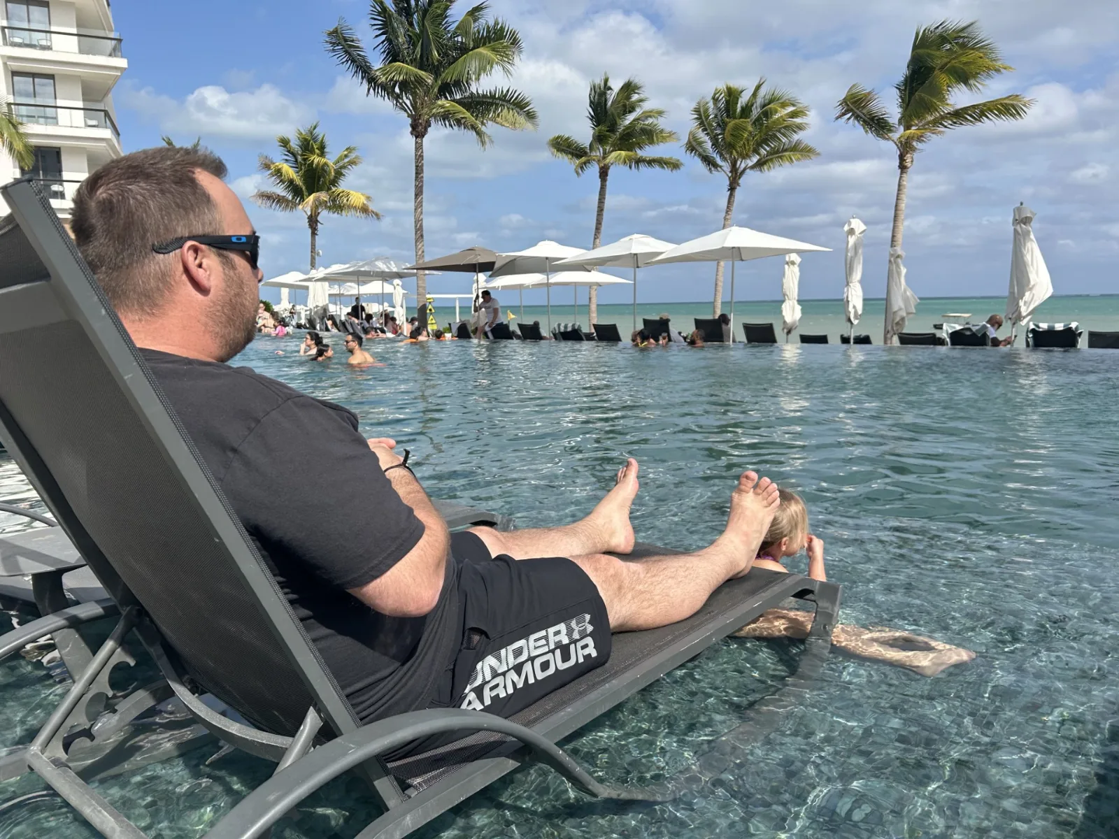 Relaxing by the active infinity pool at Hilton Cancun